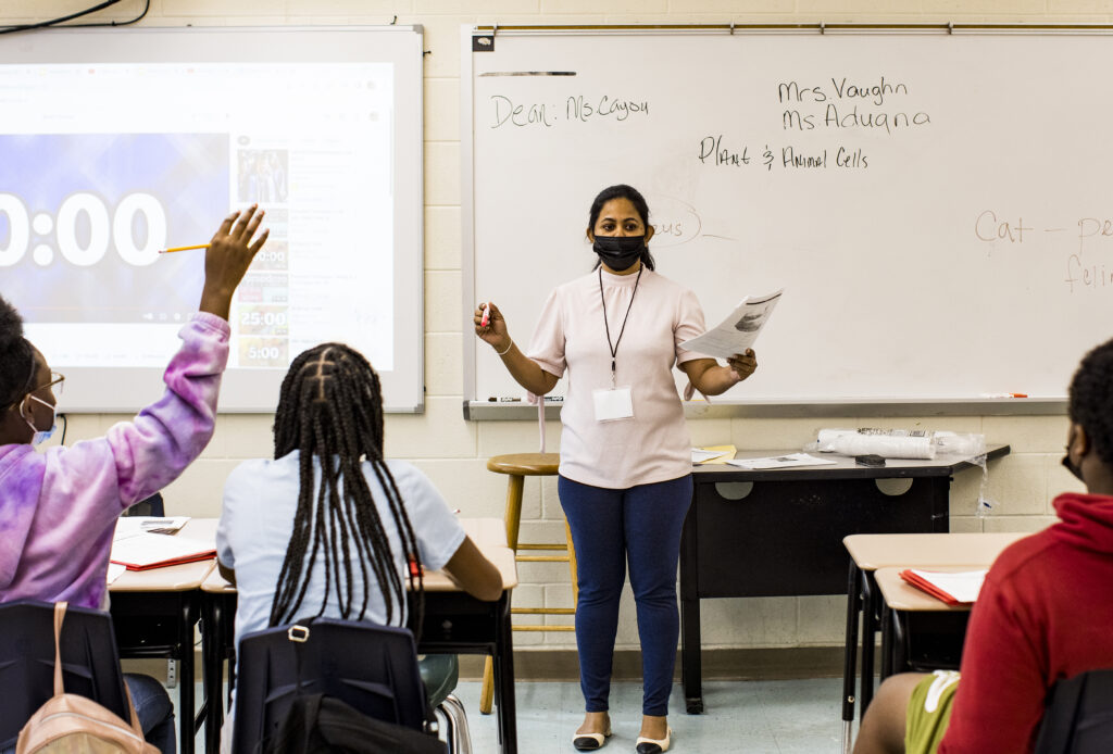 Imali Ariyarathne, seventh-grade teacher at Langston Hughes Academy, stands in front of her students while introducing them to the captivating world of science